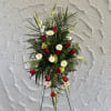 This Standing Spray is made with red and white flowers. Simple and