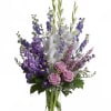 Lavender and white sympathy flowers make a grand statement in this joyful