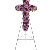 A breathtaking standing cross of majestic purple and lavender blooms remembers and