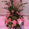 Various pink colored roses on a bed of beautiful greens. 