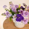 This enchanting monochromatic lavender arrangement showcases light purple lisianthus, clematis, fragrant stock