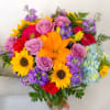A spring mix of lilies, sunflowers, roses, hydrangeas, stock and montecasino in