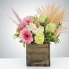 A boho arrangement featuring an eclectic mix of flowers and textures that