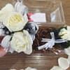 This white corsage with silver and black accents, paired with its matching