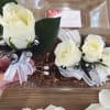 This white corsage with silver and black accents, paired with its matching