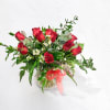 12 Red roses accented with premium greens in a  clear vase.