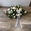 FUNERAL CASKET WITH VARIETY OF FLOWERS IN WHITE COLOR AND PERSONALIZED RIBBON