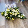 FUNERAL CASKET, VARIETY OF ROSES, CARNATIONS, RUSCUS, LILIES, PERSONALIZED AND LAMINATED CARD