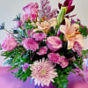 This arrangement has roses, lilies, mums, and some aster. Will be perfect