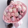 A delightful mix of pastel pink chrysanthemums, creamy carnations, and lush spray