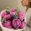 A beloved bouquet pairing vibrant pink peonies with delicate blue tweedia blooms.