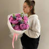 A beloved bouquet pairing vibrant pink peonies with delicate blue tweedia blooms.