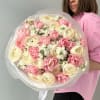 An irresistibly soft and charming bouquet of cream ranunculus, pink tulips, and