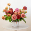 One dozen of our freshest local dahlias artfully arranged and finished with