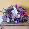 Elegant and emotional, this touching arrangement of shades of purple with delicate