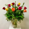Mix Colored Roses and Greenery Arranged in a Glass Vase.