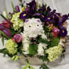 A delightful spring basket with a sweet white cat in the center.