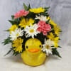 A whimsical ceramic duck planter is home to long lasting carnations and