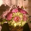 Hydrangea, Peonies, Orchids and Alstroemeria are arranged in a short cylinder