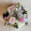 A romantic and elegant floral arrangement bursts with soft, complementary hues of