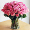 Freshly crafted pink roses arrangement in a glass vase. This luxurious bouquet