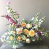 A large floral arrangement with garden roses and so much more! This