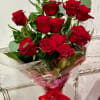 12 long stem red roses wrapped with luxurious greens of our choice.
