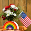 A fun spray of reds and whites in a ceramic rainbow vase!