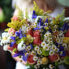 Bouquet of a mix of roses, daisies, irises and greenery
