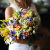 Bouquet of a mix of roses, daisies, irises and greenery
