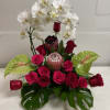 arrangement of orchids proteas and Of Course roses
please let us know your