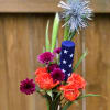 A savvy arrangement made in a glass bottle featuring a colorful array