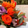 This fiery bouquet captures the essence of autumn with its vibrant orange