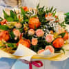 Delight in the elegance of this bouquet featuring vibrant orange roses, tender