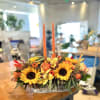 This floral centrepiece is guaranteed to create a warm and inviting atmosphere!