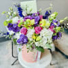 This bouquet is a beautiful blend of vibrant colors and delicate flowers