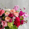 A premium full Arrangement with reds, purples, peaches and pinks in a