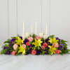 This inspirational altar piece is handcrafted of peach and coral roses, purple