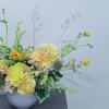 Floral focused low and sprawling design with an assortment of seasonal blooms.