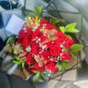 A bouquet made with red &amp; white tones and greenery, topped with