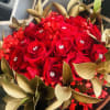 A bouquet made with red &amp; white tones and greenery, topped with