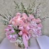 Beautiful flower arrangement featuring pink roses, pink tulips, and hydrangeas with green