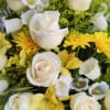 Beautiful sympathy arrangement designed with premium flowers in white, yellow and green