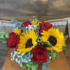 Sunflower and Roses accented by greens and babies breath will show how