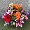 &quot;Bold and Bright&quot; is a striking arrangement in a short, wide vase