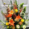 Basket arrangement filled with hydrangea, snap dragons, roses, stock, curly willow and
