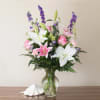 This guest favorite features beautiful Stargazer Lilies and Roses with a-swirl with