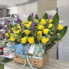 Decorated with roses, hydrangeas, green leaves, ruscus greens, solidago fillers, and monstera