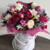 Make a statement with this lush and romantic floral arrangement designed in