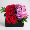 &quot;Hot, Hot, Hot&quot; is a striking floral arrangement in a short wooden